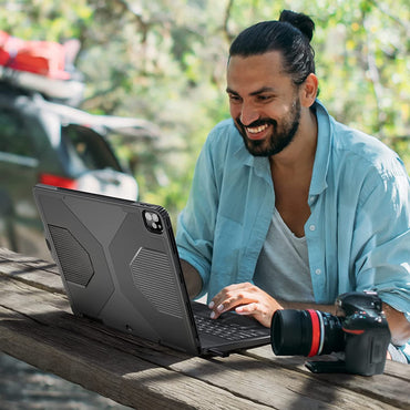 Man using iPad keyboard case outdoors